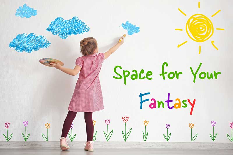 Cute little girl painting on wall in empty room